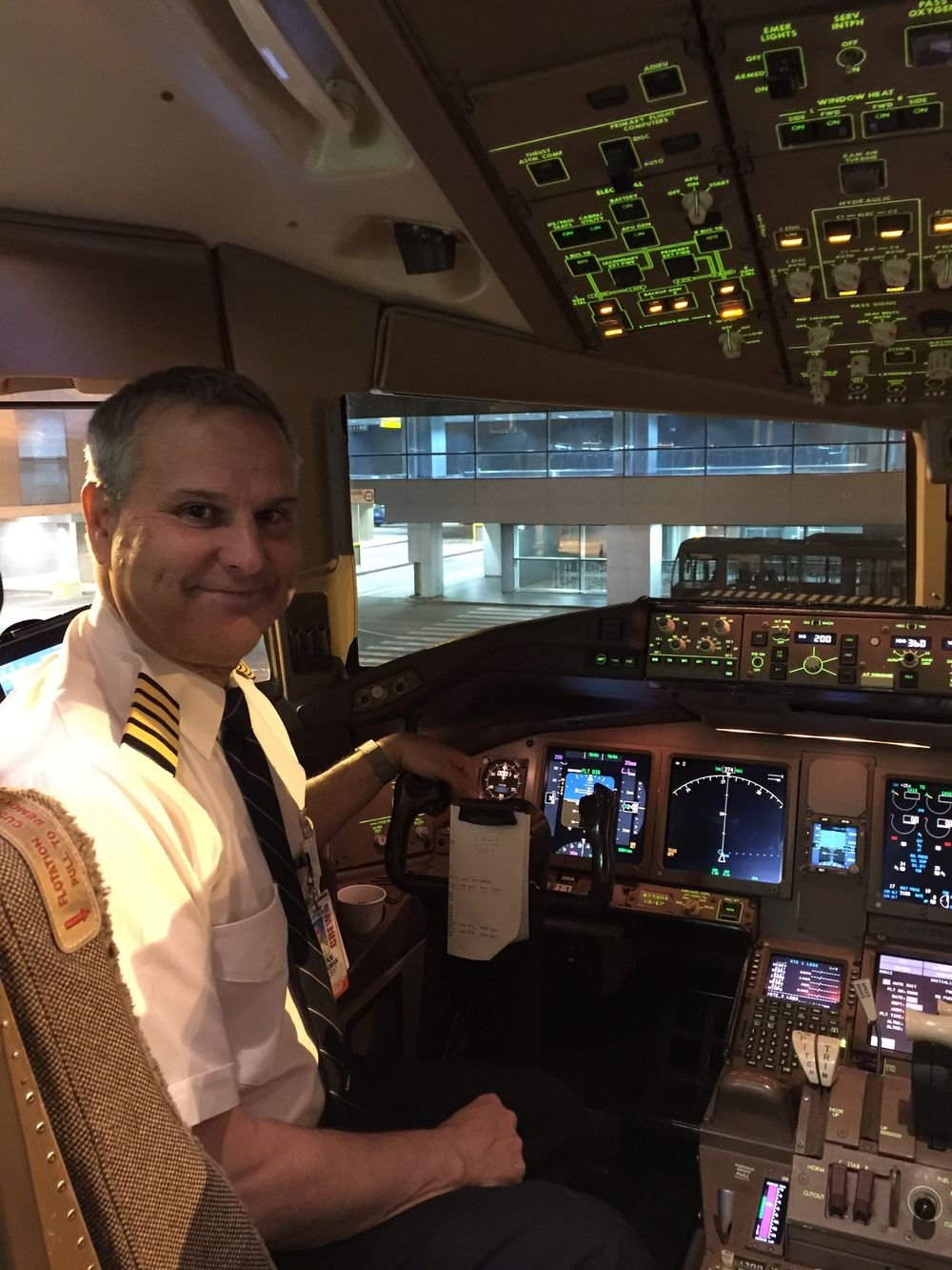 Captain Ivan Klugman in the flight deck of a wide-body airliner